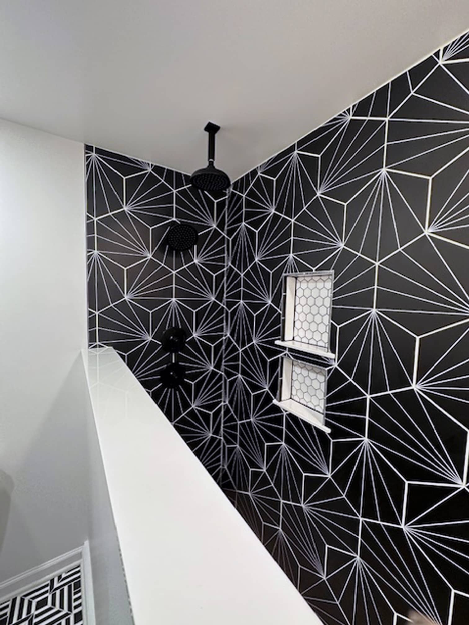 Walk-in shower featuring bold black geometric tile in a Columbus-area remodel